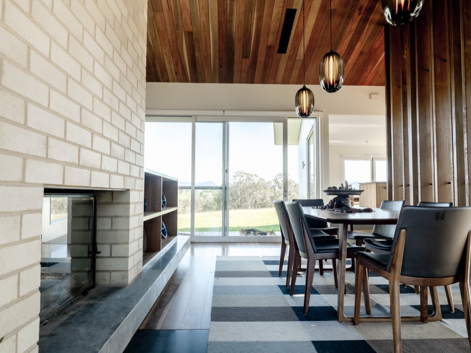 Mogilla Farm dining room with spotted gum ceiling and brick fireplace, a finished Hallbar build