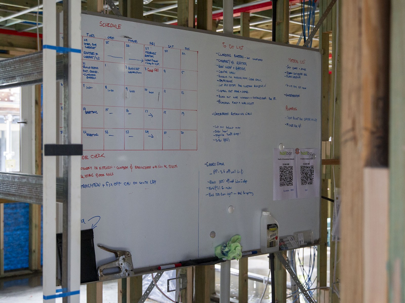 Hand-written build schedule and to-do list on the site whiteboard at Mossy Point