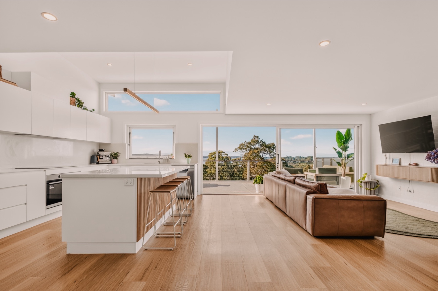 Calga Crescent open-plan kitchen and living with coastal view