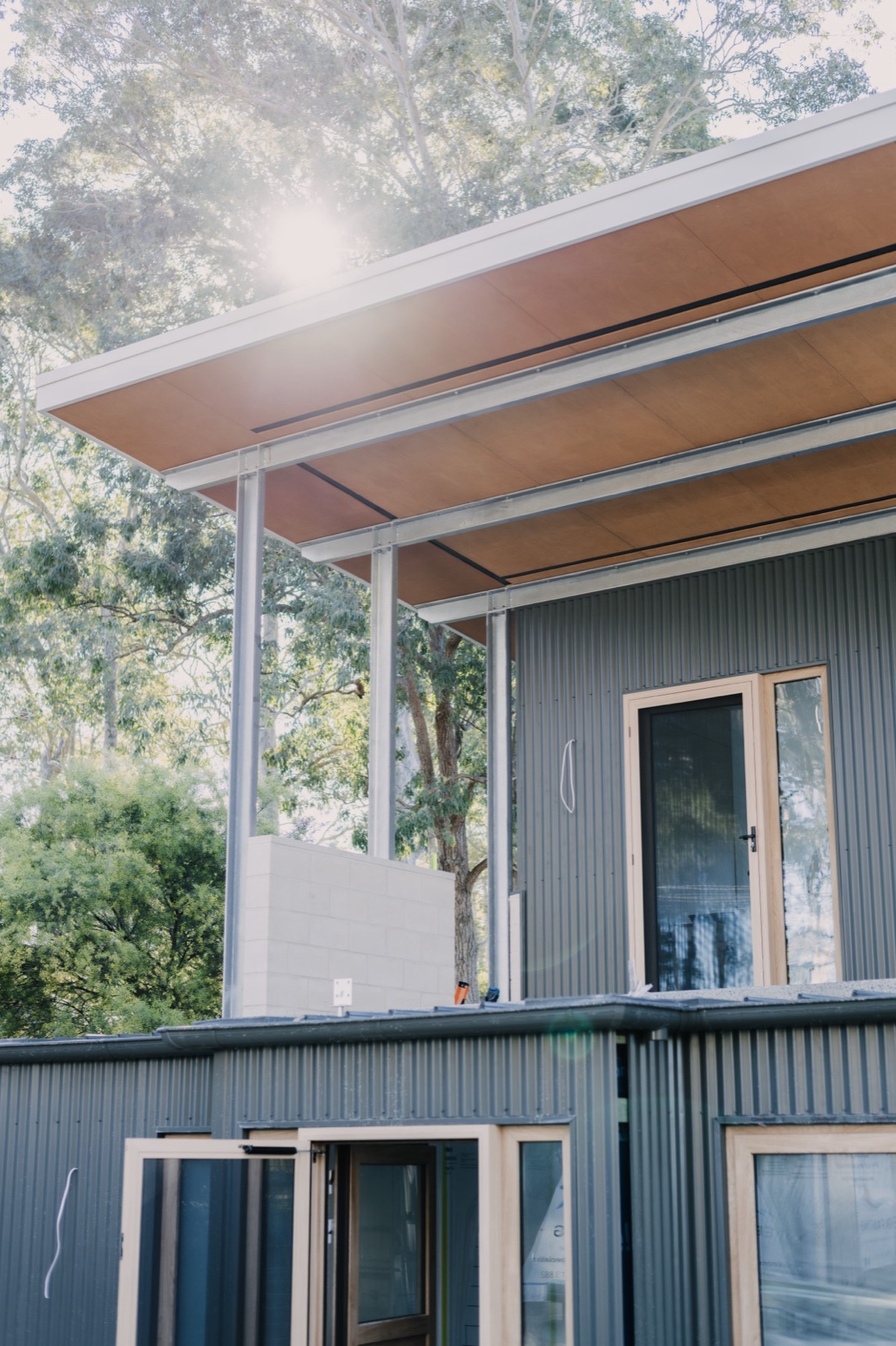 Mossy Point home under construction, dark cladding and timber windows
