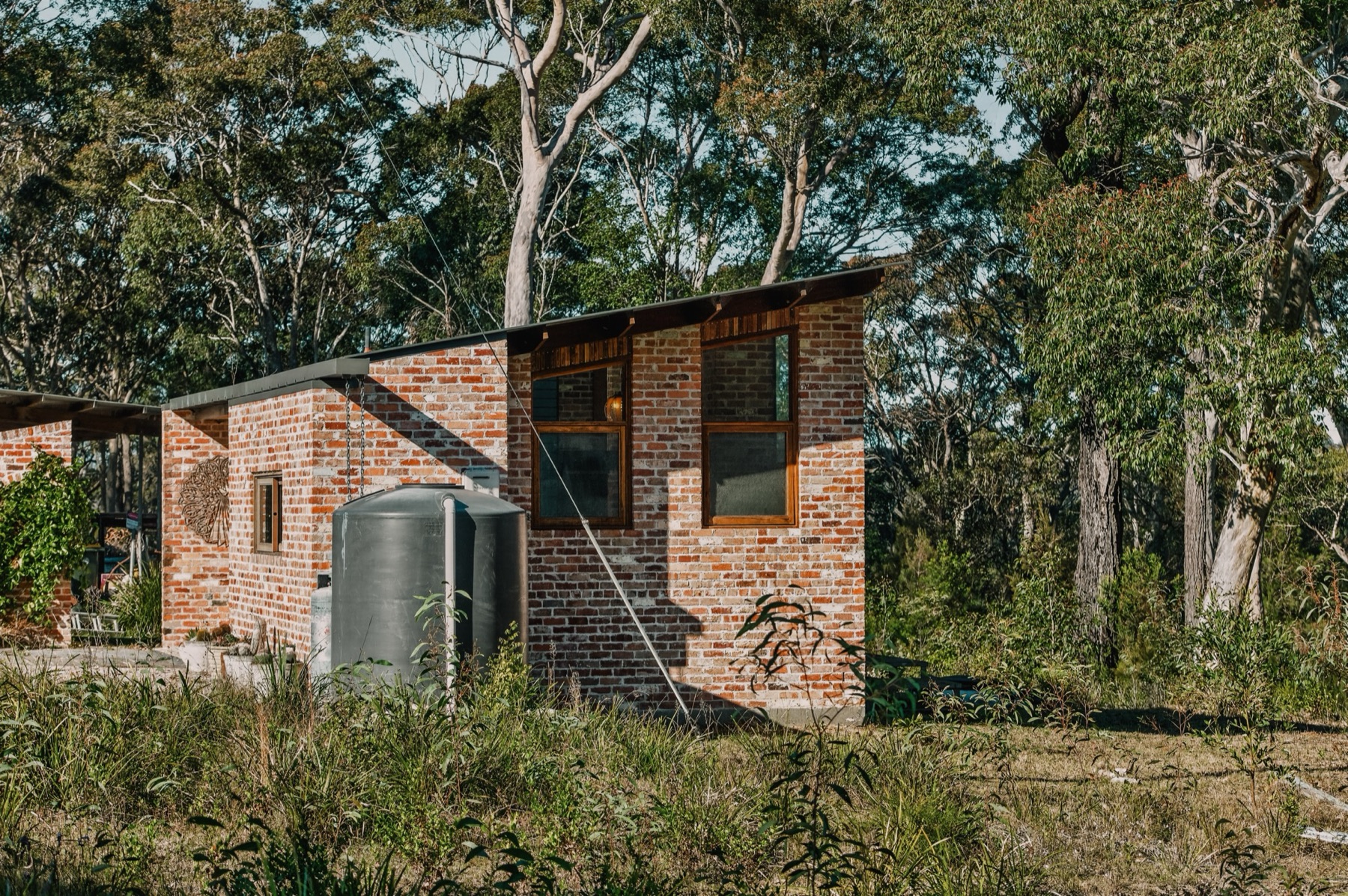 Moruya Sleepout, recycled brick building among gum trees